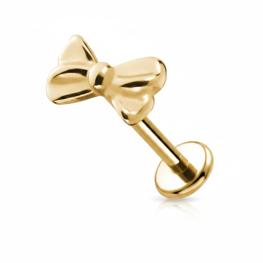 Piercing labret fiocco oro su sfondo bianco