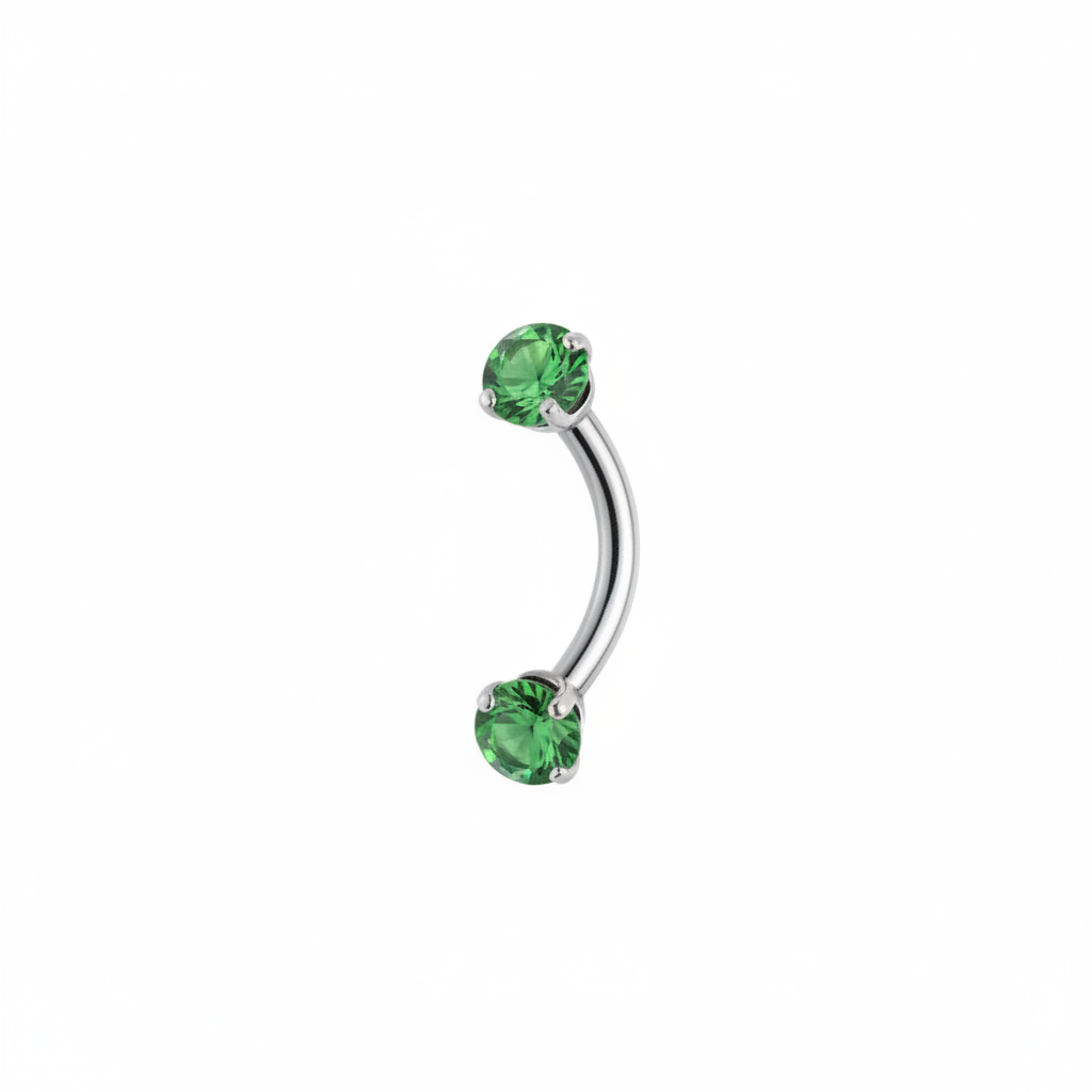 Piercing sopracciglio curvo con cristalli verdi su sfondo bianco